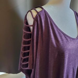 Section women purple top with cut out sleeves.